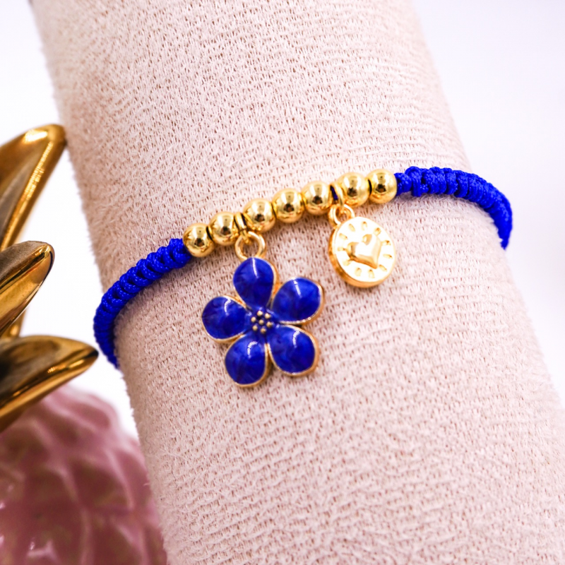 pulsera con dije flor azul